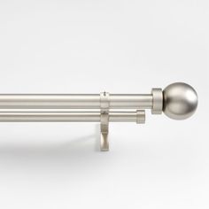 a metal curtain rod with two balls on the top and one ball on the bottom