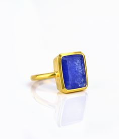 This beautiful bezel set ring is made with large rectangular faceted natural Blue Jade in 18K Vermeil Gold. The ring has a 925 stamp. Gemstone size is 13 x 18 mm. Please specify your size at checkout. Since I use natural gemstones, the stones may vary slightly in color, shape and size. Due to the nature of this stone there are natural inclusions and small internal cracks. This ring is available in two finishes: ✦ 18K VERMEIL GOLD ✦ BRIGHT STERLING SILVER Please leave me a note at checkout which Rectangular Gold Emerald Ring With Bezel Setting, Rectangular Faceted Fine Jewelry Ring, Fine Jewelry Faceted Rectangular Ring, Fine Jewelry Rectangular Faceted Ring, Rectangular Gold Sapphire Ring Gift, Rectangular Sapphire Ring In Gold Setting, Rectangular Gemstone Ring For Everyday, Rectangular Faceted Ring As A Gift, Gold Rectangular Sapphire Promise Ring