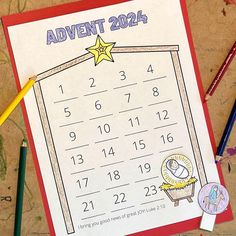 a printable calendar with pencils and crayons on the table next to it