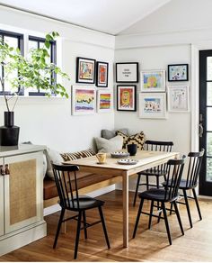 a dining room table with four chairs and pictures on the wall above it that says colorful home design