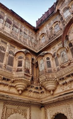 an ornate building with many windows and balconies on the outside, in india