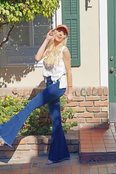 The best looking Bell Bottoms since the 70's! High waisted elastic waist with the perfect amount of stretch! Back pockets for convenience. Fringe bottoms take it to the next level. Believe us you need this. Definitely a wardrobe essential. Model is 5'9 and wearing a small Details Best Seller Fitted High Rise– True To Size 65% Cotton, 33% Polyester and 2% Spandex Machine Wash Cold, Inside Out, Tumble Dry Low Dark Wash Elastic Waistband Stretchy Fabrication Back Pockets Bell Bottom Raw Distressed Retro Mid-rise Stretch Bottoms, Retro Stretch Mid-rise Bottoms, Casual Flare Bottoms With Elastic Waistband, Retro High Rise Stretch Bottoms, Retro High-rise Stretch Bottoms, Retro Stretch High Rise Pants, Retro High Rise Stretch Pants, Retro High-rise Stretch Pants, High Rise Bottoms With Elastic Waistband For Day Out