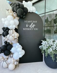 balloon arch with i can't say i do without you written on the front