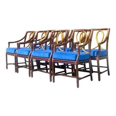 six chairs with blue cushions are lined up in a row on a white background for display