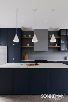 an image of a kitchen setting with blue cabinets and white counter tops, along with two pendant lights over the island