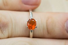 This is a beautiful and very unique Orange Fire Opal from Mexico set in Sterling Silver! This stone has an outstanding and well defined bright orange color with amazing luster and good clarity! Mexican Opals have seen increased demand and pricing over the past few years with their varying range of colors and the clarity. Opal is October's Birthstone! This nicely sized 7mm x 5mm Oval Cut Fire Opal weighs 0.590cts and will go great with many styles and occasions and with the four prong setting, th Classic Orange Jewelry With Prong Setting, Orange Brilliant Cut Jewelry For Gift, Orange Round Jewelry With Brilliant Cut, Fire Opal Ring, Gem Ring, Opal Ring, October Birth Stone, Opal Rings, Bright Orange