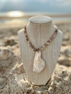 One of One Goddess energy, wearable Art. Original shell reproduced in resin, strung on mother of pearl beads with a magnetic clasp for ease. The original shell was found on the coast of Florida & was 3D captured & reproduced to share with goddesses all over the world. The waves & tides were the sculptor & inside the design of the shell is a silhouette of a woman as you can see in the 2nd photo. The goddess energy in the one of a kind hand painted in pearlized paint beauty is extraordinary just l Unique Mother Of Pearl Shell Pendant Necklace, Mother Of Pearl Shell-shaped Necklace For The Beach, White Shell-shaped Mother Of Pearl Necklace, Elegant Shell-shaped Mother Of Pearl Necklace, Adjustable Shell-shaped Mother Of Pearl Jewelry, Goddess Energy, Pearl Shell, Shell Pendant, Sculptor