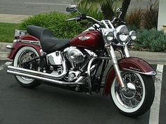 a red motorcycle parked in a parking lot