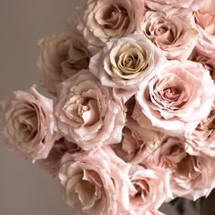 a vase filled with pink flowers on top of a table