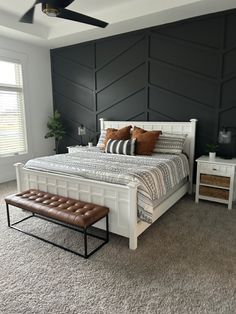 a white bed sitting in a bedroom on top of a carpeted floor next to a window