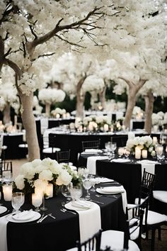 tables with black and white linens are set up for an event