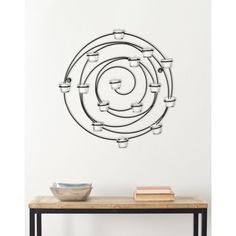 a table with a bowl on it and a wall sticker in the shape of a spiral