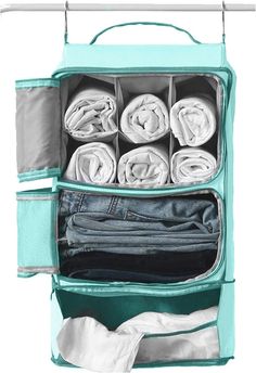 an open suitcase filled with clothes and folded shirts