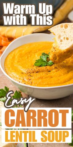 a bowl of carrot lentil soup with a piece of bread sticking out of it