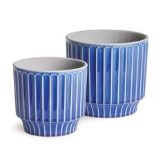 two blue vases sitting next to each other