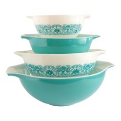 three bowls stacked on top of each other in turquoise and white designs, with one bowl holding two smaller bowls