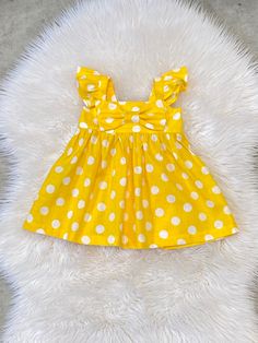 "Beautiful Big Bow Girls dress. Back has elastic for comfort and a great fit. The listing is for one bow dress!  These are the APPROXIMATE measurements of the dresses from shoulder to hem: size/chest/length 0-3m / 14\"/13\" 3-6m /16/14\" 6-9m /17\"/15\" 9-12m /18\"/16\" 12m-18m /19\"/17.5\" 18m-24m /20\"/19\" 2t /21\"/20\" 3t /22\"/20.5\" 4t / 23\"/22\" 5t /24\"/23\" 6y / 25\"/24\" 7y / 26\"/25\" 8y /27\"/26\" Please note: Due to variation in each computer monitor there may be slight differences between the photo shown and the actual item. Care Instructions: Fabric is 100% cotton.  Hand wash or wash on delicate cycle cold water. Hang dry or lay flat. Iron if needed. ATTENTION: This item contains small parts that can pose a choking hazard to young children and infants. Never allow your chil Cute Polka Dot Cotton Dress, Cute Cotton Dress With Bow Tie Back, Fitted Yellow Dress With Bow, Summer Cotton Dresses With Bow Print, Cotton Summer Dresses With Bow Print, Summer Cotton Dress With Bow Print, Yellow Spring Dress With Bow, Cute Polka Dot Dress With Ruffles, Yellow Fitted Dress With Flutter Sleeves