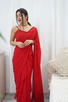 Amp up your style in this stunning pre stitched saree that has an alluring frilled design. With an embroidered strappy blouse and a similar belt, this saree can be worn for weddings, cocktail events and evening parties!Style Pre-stitched Frill Saree Scarlet Red Belted Style Embroidered Detailing Strappy blouse Viscose georgette fabric Specifications Model height - 5'9" Model wearing - S Frill Saree, Pre Stitched Saree, Strappy Blouse, Stitched Saree, Red Belt, Cocktail Event, Belt Style, Georgette Fabric, Indian Wedding Dress