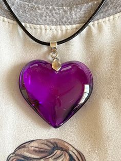 "Large purple puff crystal heart pendant, made of highest quality glass. Beautiful brilliant purple heart, classic pendant to be used for any occasion, symbol of love and joy Size of heart:  1 3/4x1 3/4inches (4.5x4.5cm) Leather cord 19\" (48cm)long including extender Total Length of necklace. 11 inches (28cm)" Purple Heart Aur, Deep Purple Gifts, Luxury Purple Jewelry For Valentine's Day, Heart Crystal Pendant Necklace, Purple Heart Locket, Cheap Purple Heart-shaped Necklace, Purple Cute Necklaces, Puff Heart Glass Necklace, Cheap Purple Glass Jewelry