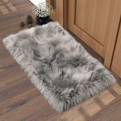 a rug that is on the floor in front of a kitchen cabinet and counter top