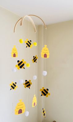 a baby crib mobile with bees and honeycombs hanging from it