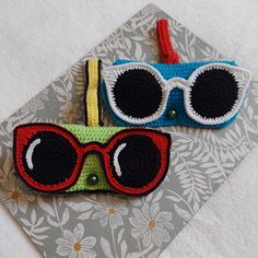 two crocheted eyeglasses are sitting on a table