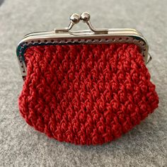 a red crocheted purse sitting on top of a table