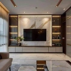 an elegant living room with marble walls and flooring, large television on the wall