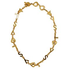 YVES SAINT LAURENT vintage gold tone iconic necklace featuring YSL initials, hearts and stars links. T-bar closure and love hearts toggles. Cursive signature YVES SAINT LAURENT embossed on the love hearts toggles. Embossed YSL Made in France. Indicative measurements : adjustable length from approx. 45 cm (17.72 inches) to approx. 49.5 cm (19.49 inches). Material : Gold tone metal hardware. NOTES - This is a preloved vintage item, therefore it might have imperfections. - Colors may differ slightl Cursive Signature, Saint Laurent Vintage, Stars Necklace, Hearts And Stars, Love Hearts, Black Spot, Link Necklace, Star Necklace, Metal Hardware