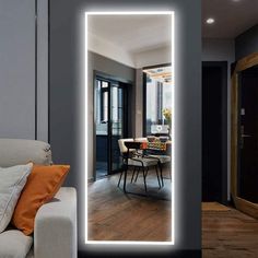 a living room with a couch and a large mirror