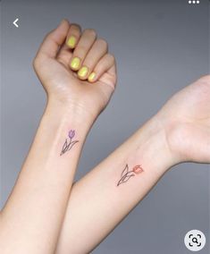 two wrist tattoos with flowers on them, one is pink and the other is yellow