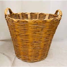 a large wicker basket sitting on top of a white surface