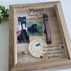 a wooden frame with pictures and magnets on it, including a dog's name