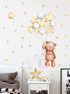 a child's bedroom with a teddy bear wall decal and stars on the wall