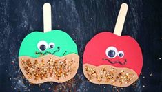 two popsicles with googly eyes and glitters on them, sitting next to each other