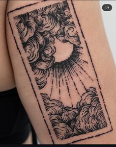 a woman's arm with clouds and sun tattoo on it