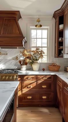 a kitchen with wooden cabinets and marble counter tops