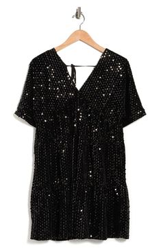 This sequined baby doll dress is the perfect level of cool. Mini length V-neck V-back Tie back Short sleeves Sequined 100% polyester Hand wash cold Lay flat to dry Imported Model stats: 5'10", 32" bust, 25" waist, 36" hip. Model is wearing size S. Black V-neck Mini Dress With Contrast Sequin, Black V-neck Sequin Dress For Night Out, Black Embellished V-neck Mini Dress, Black V-neck Sequin Dress With Contrast Sequins, Black V-neck Sequin Dress For Summer, Black V-neck Sequin Summer Dress, Black V-neck Sequin Dress For Holiday, Holiday Black V-neck Sequin Dress, Black Holiday V-neck Sequin Dress