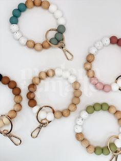 four different bracelets with wooden beads on them