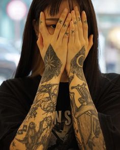 a woman covering her face with both hands