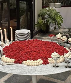 a table topped with lots of desserts covered in raspberries