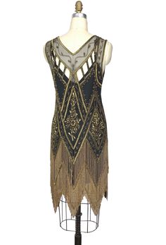 The epitome of Art Deco design…our Icon Gown is positively decadent! With a deep v neckline, the Icon features front and back panels accented with a sparkling floral design. The gown is finished with a scalloped hem dripping with beaded fringe. It is the classic flapper look for a modern woman. The Icon is one of our best selling dresses for a reason! Antique gold beading on black mesh. Sheer, so a slip is recommended. Shown with our bias glamour slip in black. XS……bust 30-34", waist 26-30", hip Gatsby Gown, 1920s Wedding Dress, 1920's Wedding, Beaded Wedding Dress, 1920s Wedding, Art Deco 1920s, Orient Express, 1920s Flapper, Beaded Wedding