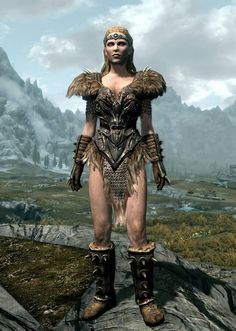 an image of a woman in armor standing on a rock with mountains in the background