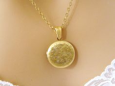 Locket Necklace, Gold Round Locket Necklace, Etched Photo Picture Necklace Floral, Mothers Day Gift Jewelry Christmas Birthday Gift Holds two 20 mm photos - Beautiful gold round locket etched with flowers and swirls holds 2 precious photos close to her heart. This timeless treasure will make a lovely gift for weddings, anniversary, Mothers Day, birthdays and other special occasions. This beautiful Art Nouveau/Victorian locket will become her go-to necklace for everyday wear. Length: 18 inches Lo Elegant Birthday Locket Jewelry, Valentine's Day Round Locket Necklace, Vintage Round Locket Necklace For Anniversary, Vintage Round Locket Necklace For Mother's Day, Vintage Round Disc Necklace As Gift, Vintage Round Disc Necklace For Gift, Vintage Gold Jewelry For Birthday Gift, Classic Round Locket Necklace As Gift, Classic Round Locket Necklace For Gift