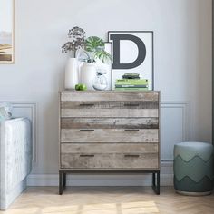 a living room with a white couch and wooden dresser