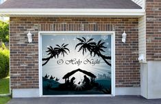 a garage door decorated with palm trees and nativity scene