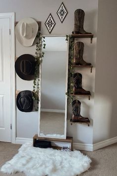 a white mirror sitting on top of a wooden shelf next to a wall mounted hat rack