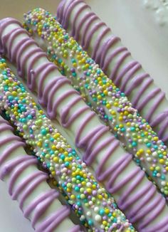 there are many candy sticks that have been decorated with icing and sprinkles