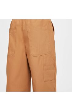 Your child will find uses for every one of the pockets while playing hard in these wide-leg carpenter pants made from durable cotton canvas. 25 1/2" inseam; 22" leg opening; 14" front rise; 15" back rise (size XL) Zip fly with button closure Back elastic waist Front slant pockets; back patch pockets; tool pockets 100% cotton Machine wash, tumble dry Imported Nike Cargo Bottoms, Nike Casual Pants With Cargo Pockets, Casual Nike Cargo Pants With Side Pockets, Nike Utility Cargo Pants With Side Pockets, Casual Nike Cargo Pants With Hip Pockets, Utility Cotton Wide Leg Pants With Multiple Pockets, Cotton Utility Wide Leg Pants With Multiple Pockets, Wide Leg Cotton Utility Work Pants, Utility Wide-leg Cotton Work Pants