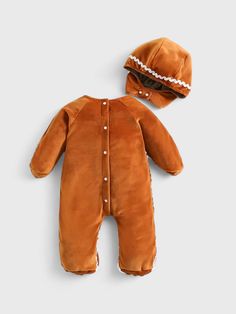 Dress your little one in this sweet and cuddly gingerbread man outfit! Made from soft plush fabric, this costume features adorable gingerbread detailing with icing-like trim and button accents. The cozy jumpsuit design keeps your baby warm and comfortable, perfect for holiday photos or festive events. Complete with a matching hood, your baby will look like a delightful gingerbread cookie come to life! Gingerbread Baby Photo, Gingerbread Customes, Infant Gingerbread Costume, Gingerbread Man Outfit, Adult Gingerbread Costume, Gingerbread Man Costume, Brown Winter Onesie For Playtime, Gingerbread Man Costumes, Jumpsuit Design